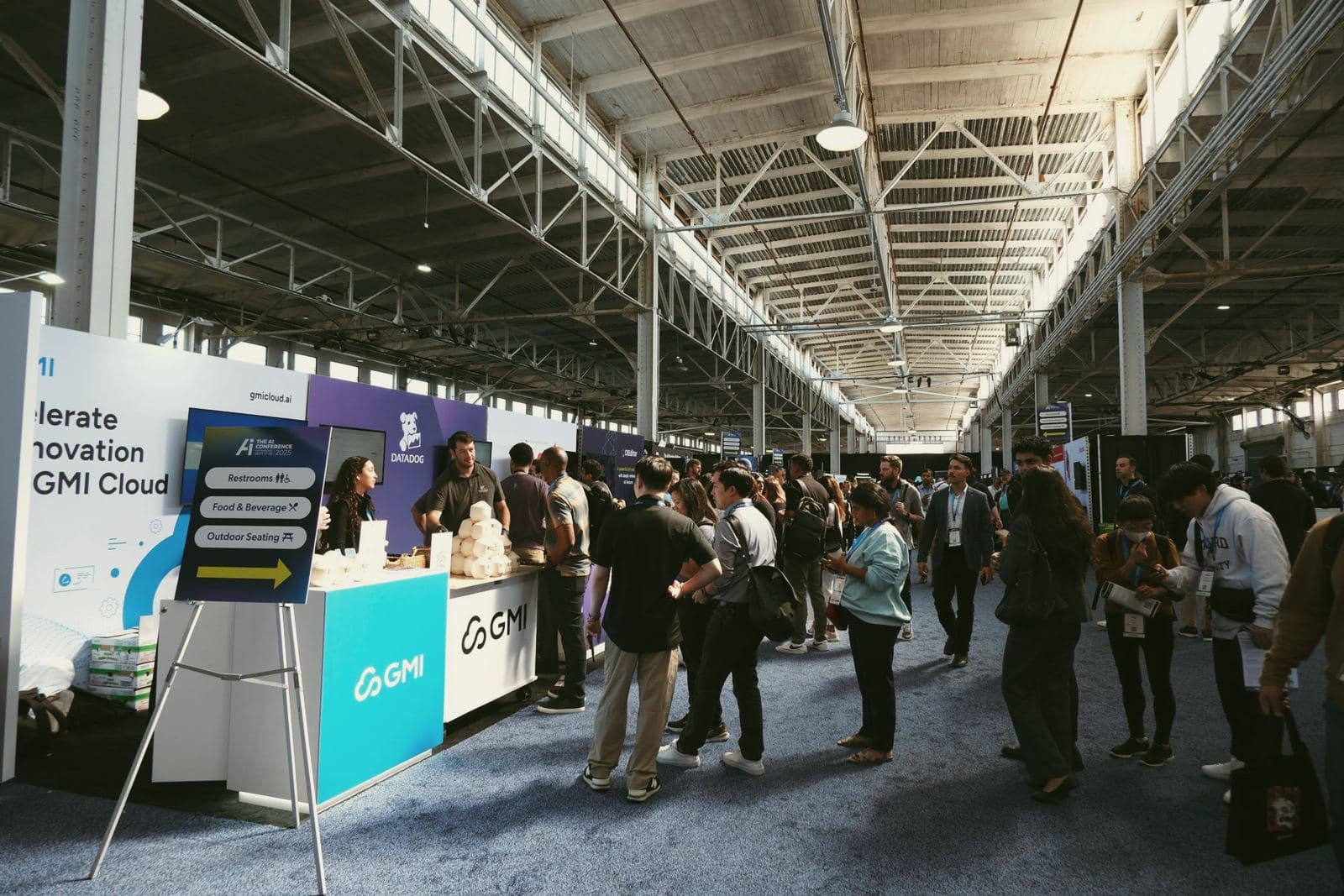 Line of attendees at the GMI Cloud booth serving stamped coconuts at The AI Conference