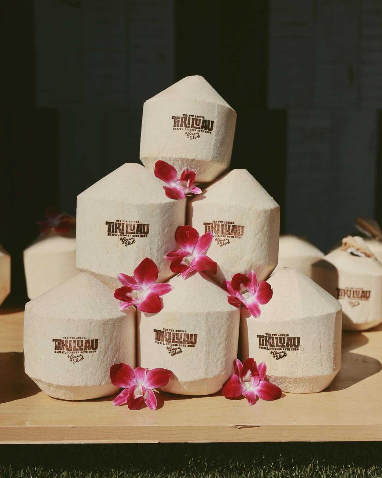 Pyramid of Tiki Luau-stamped coconuts with orchids