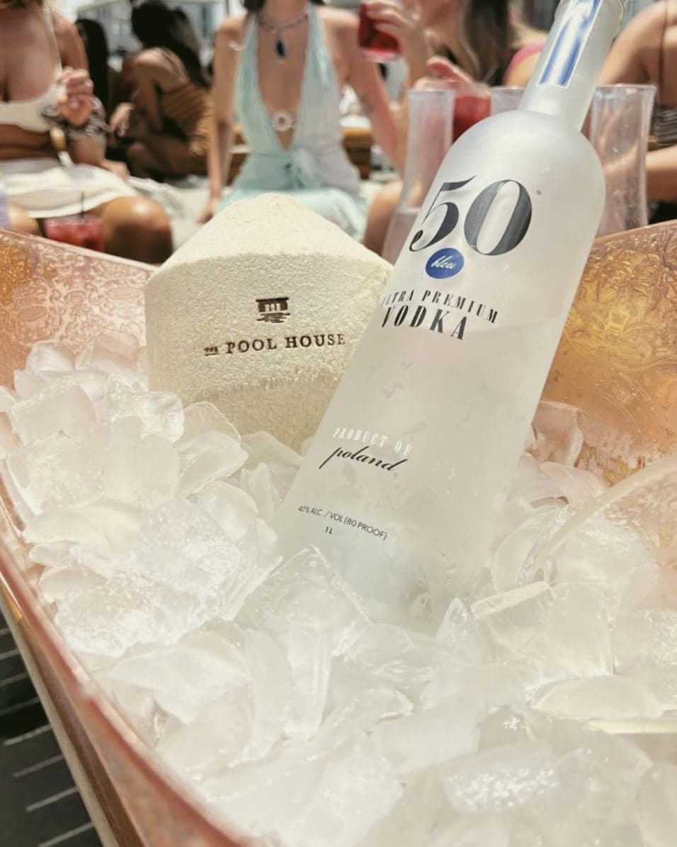 Pool House coconut on ice beside a bottle service bucket
