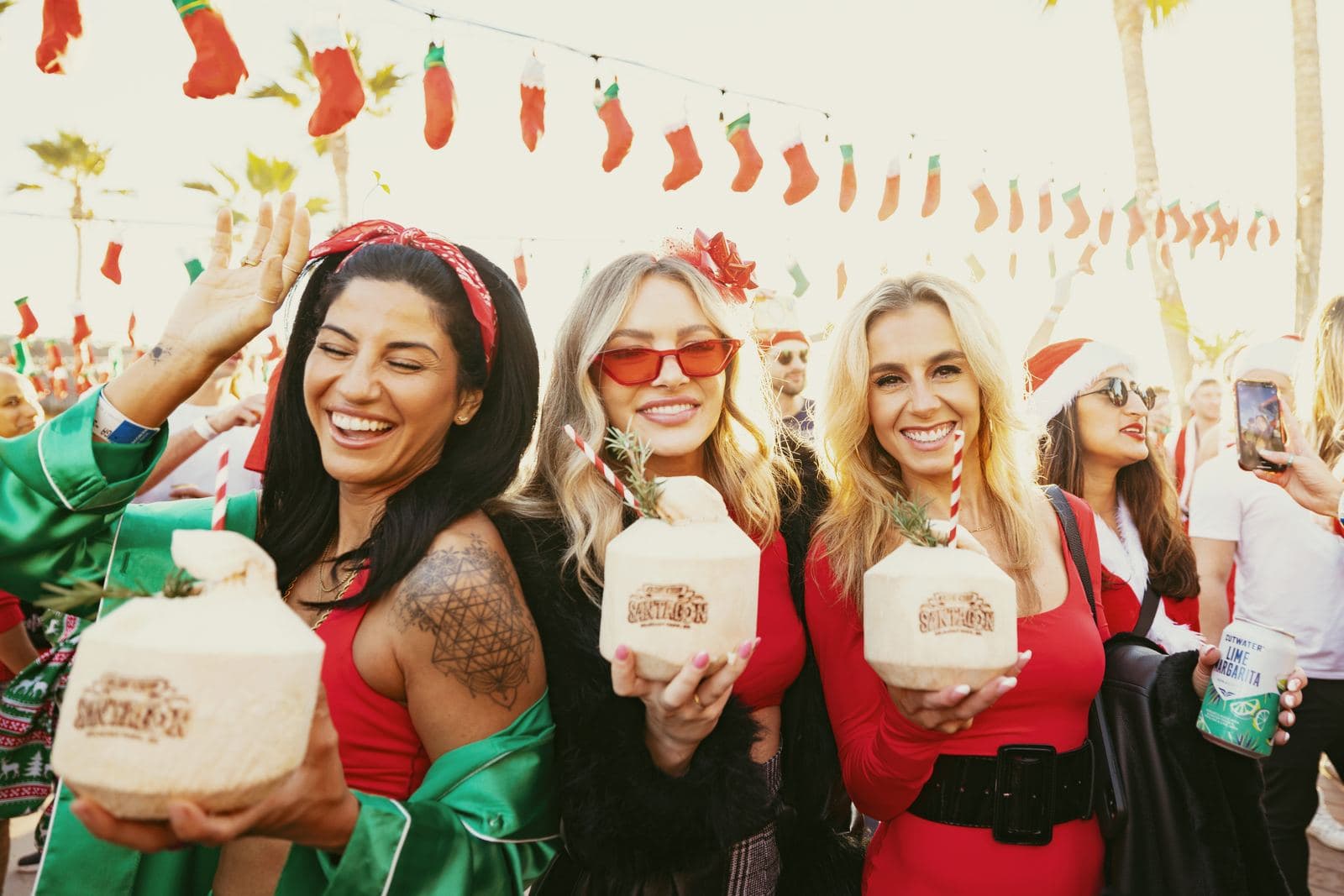 Santas holding stamped coconuts at SantaCon
