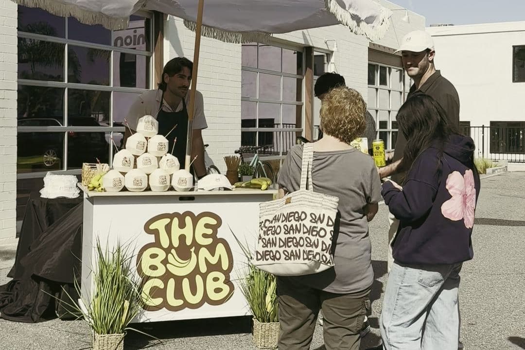 Guests in line at the Bum Club coconut cart outside the Sun Bum shop