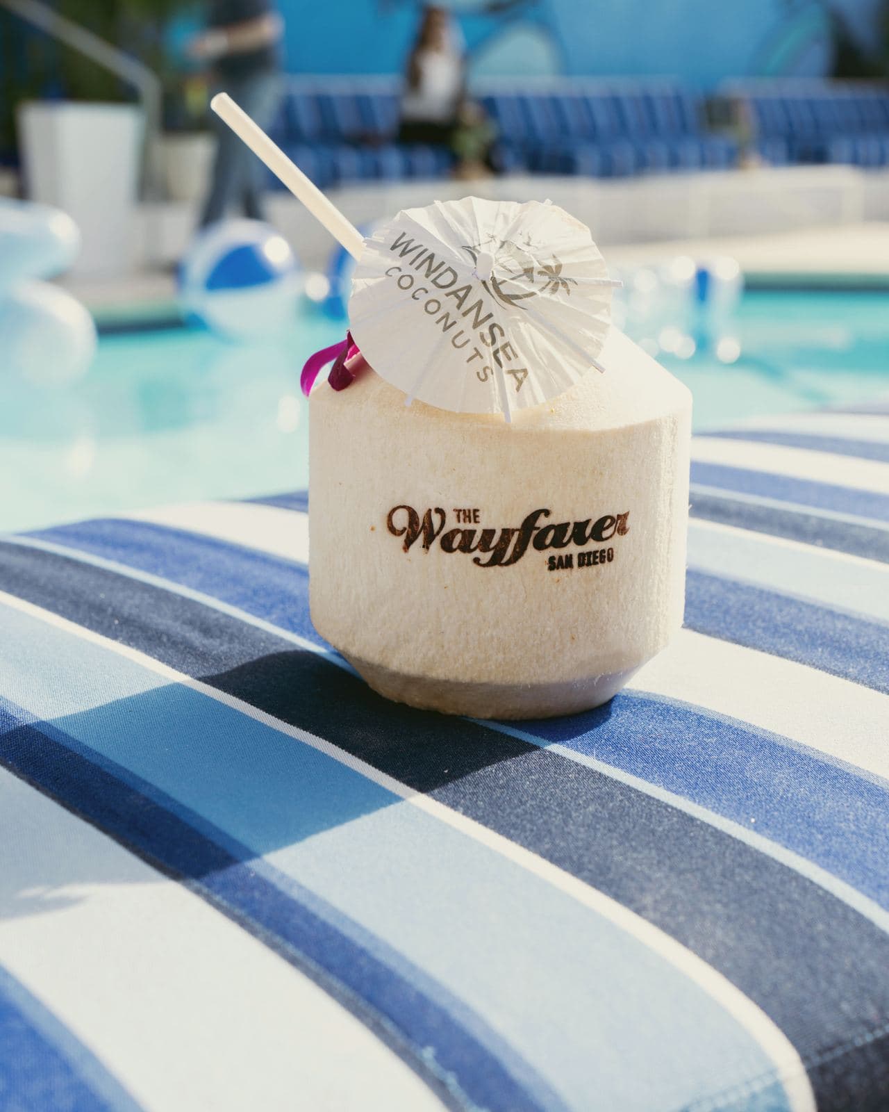 Coconut stamped for The Wayfarer San Diego on a poolside lounger