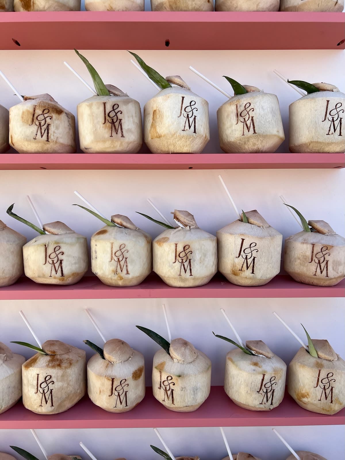 Shelves of coconuts stamped with the couple's monogram